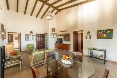 Bright bedroom inside beachfront house in Farallon with wood ceiling, split AC, garden views