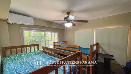 Large terrace overlooking the Pacific Ocean with dining and lounge areas in Chumico Panama