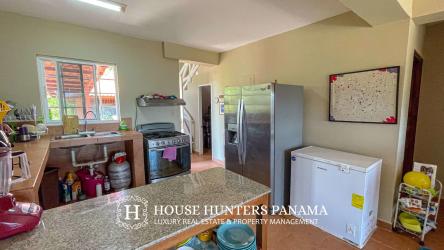 Contemporary kitchen with granite countertops and stainless steel appliances in Panama beach estate