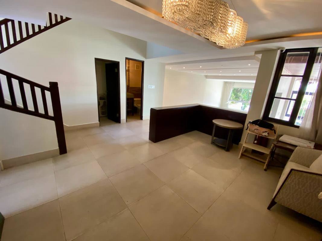 Spacious kitchen with blue countertops, white cabinets and tiled backsplash in Dos Mares duplex Panama City