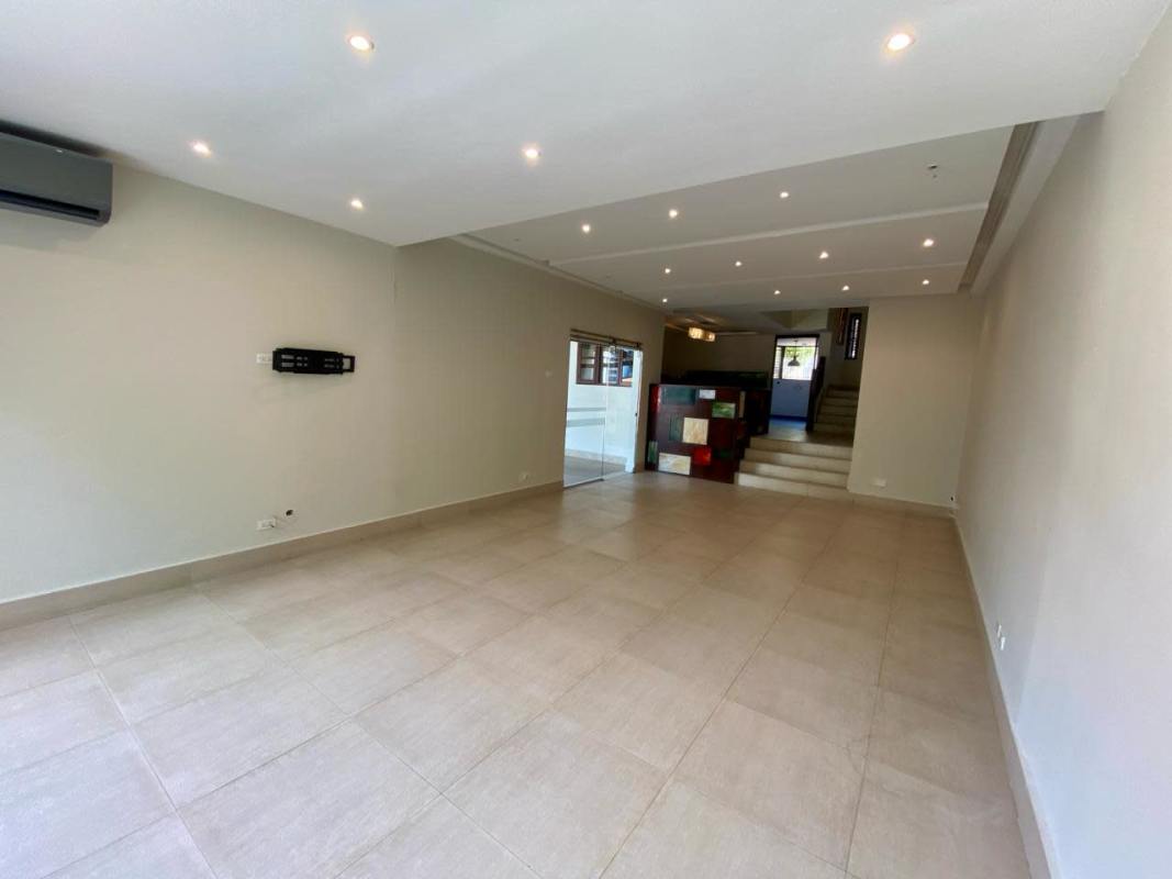 Modern bathroom with double sink vanity, marble countertop and large mirror in duplex Dos Mares Panama