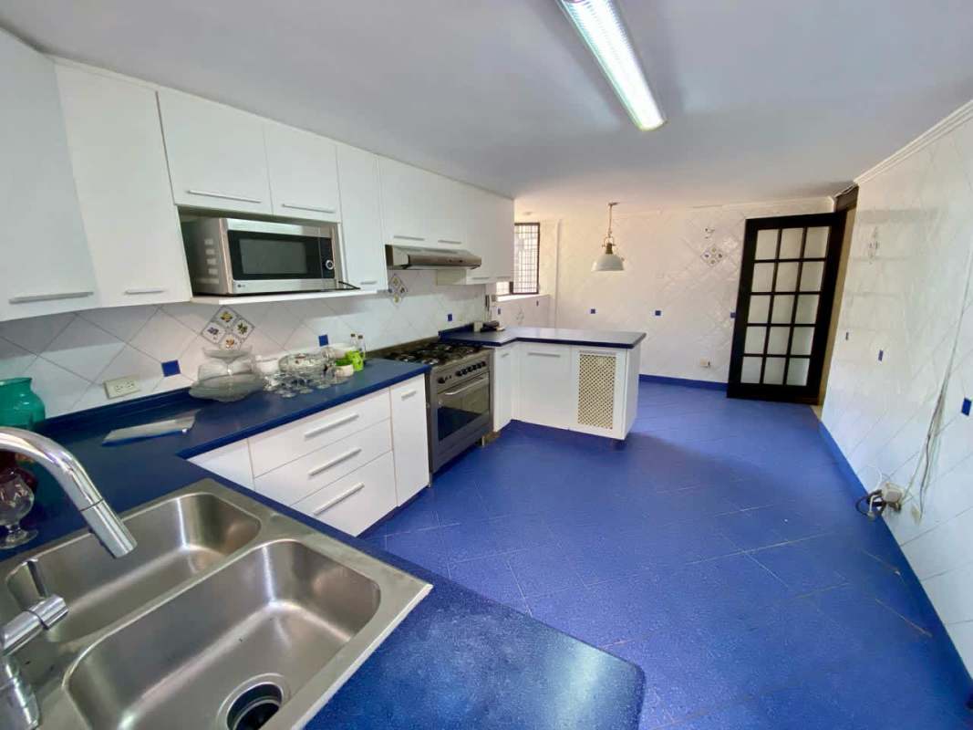 Contemporary bathroom with glass shower enclosure and mosaic tiles in Panama duplex house