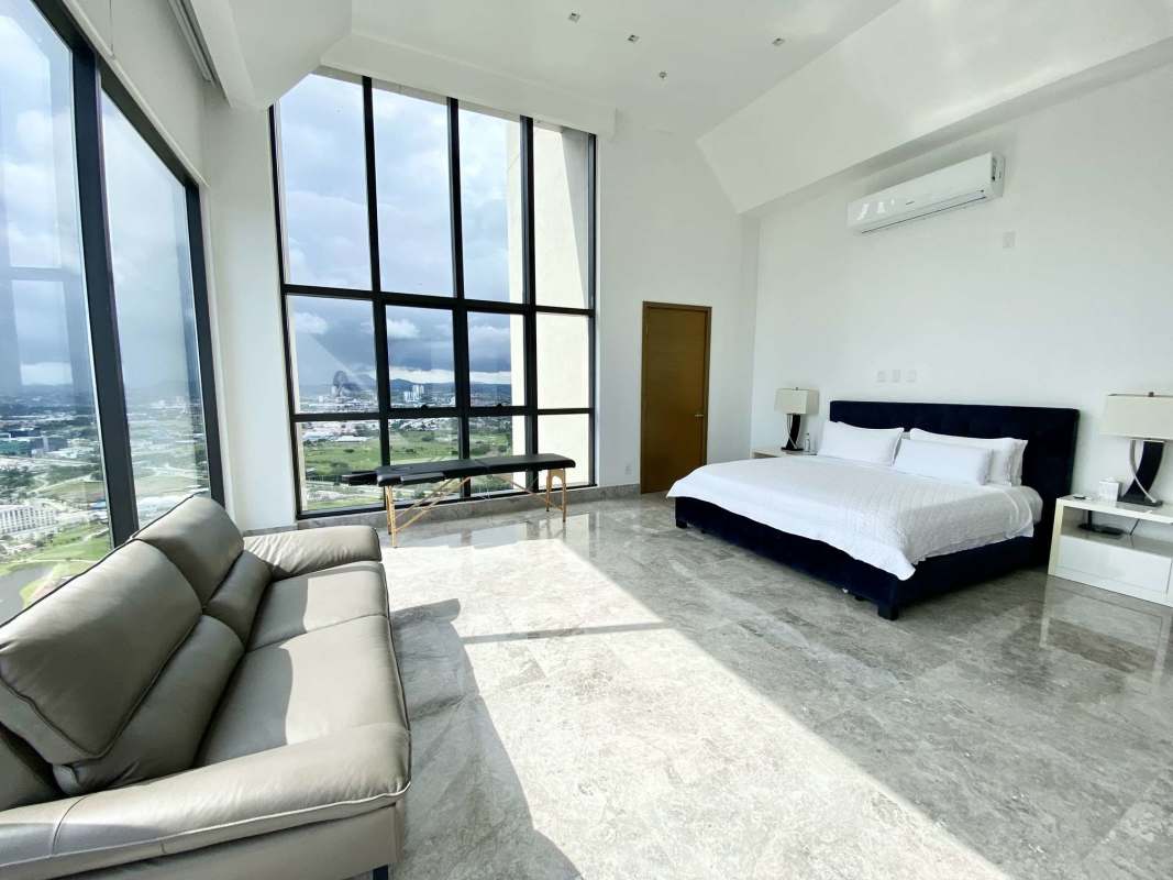 Large modern bedroom with floor-to-ceiling windows and golf views at Empire Residences Santa Maria Panama