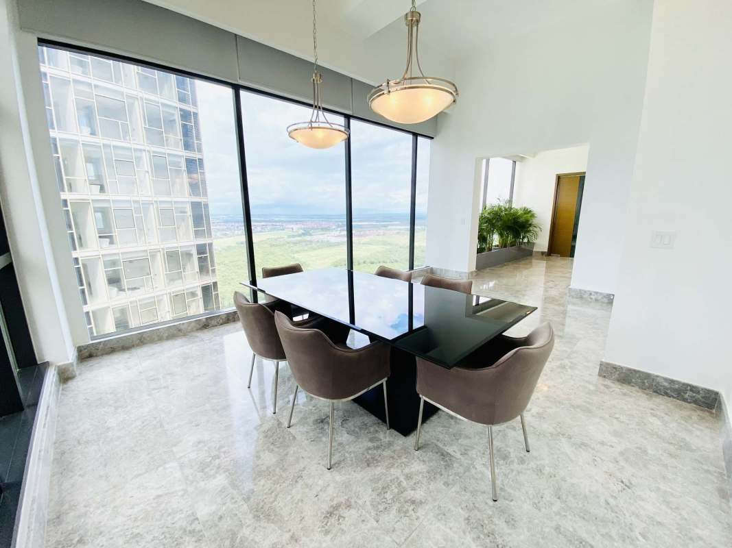 Modern dining room with panoramic city and golf course views Empire Residences Santa Maria Panama