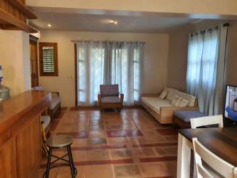 Two-story tropical villa with balcony, garden and terracotta facade at Ocean Lofts Pedasi Panama