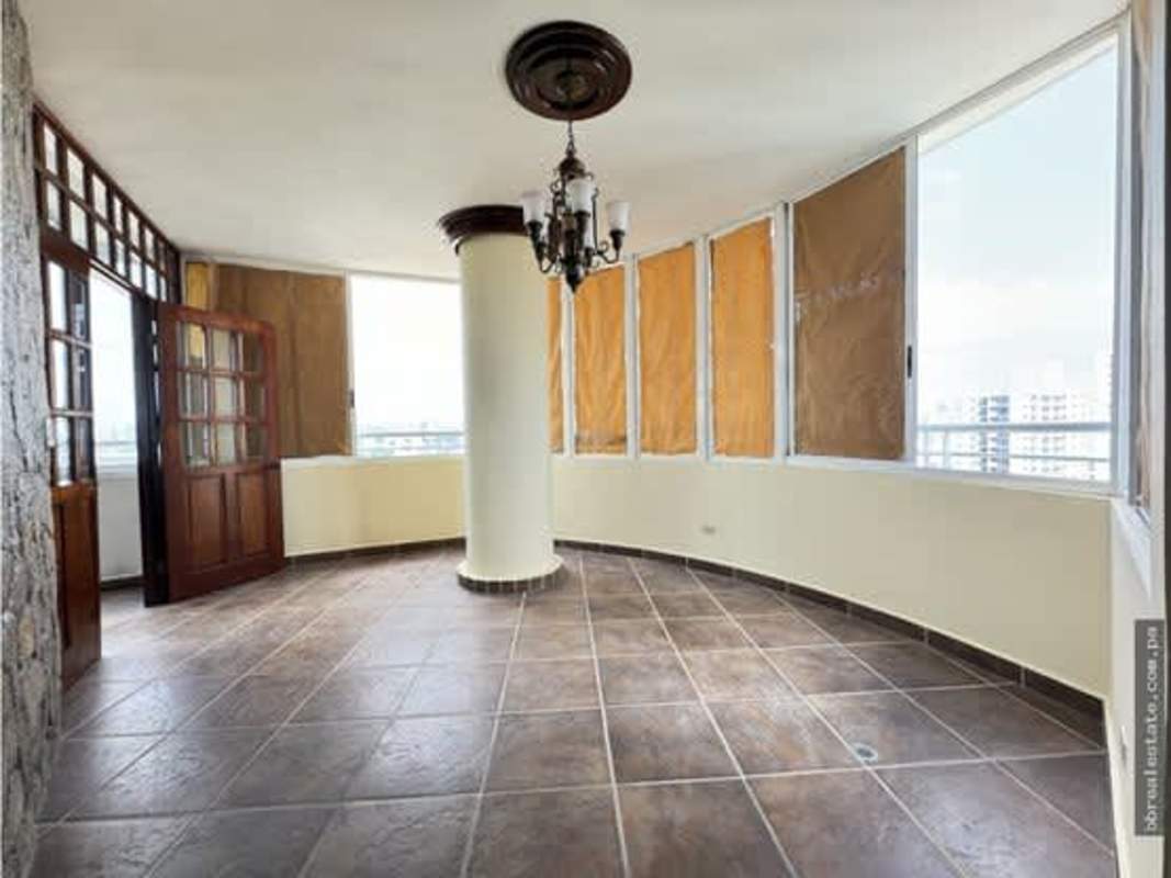 Enclosed panoramic terrace balcony with tile flooring and wooden framed windows in PH Vista Park Panama