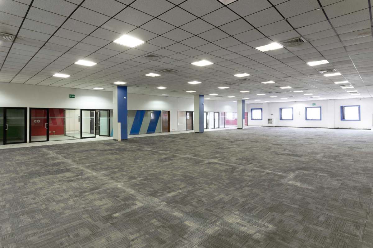 Large empty commercial unit with glass walls and carpet Via Cincuentenario Chanis Panama