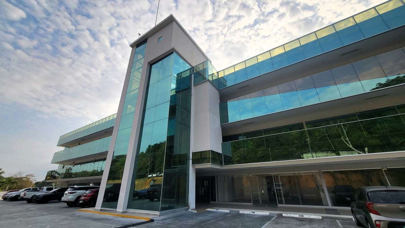 Empty retail commercial unit with glass front overlooking parking area at Terrazas de Albrook Panama
