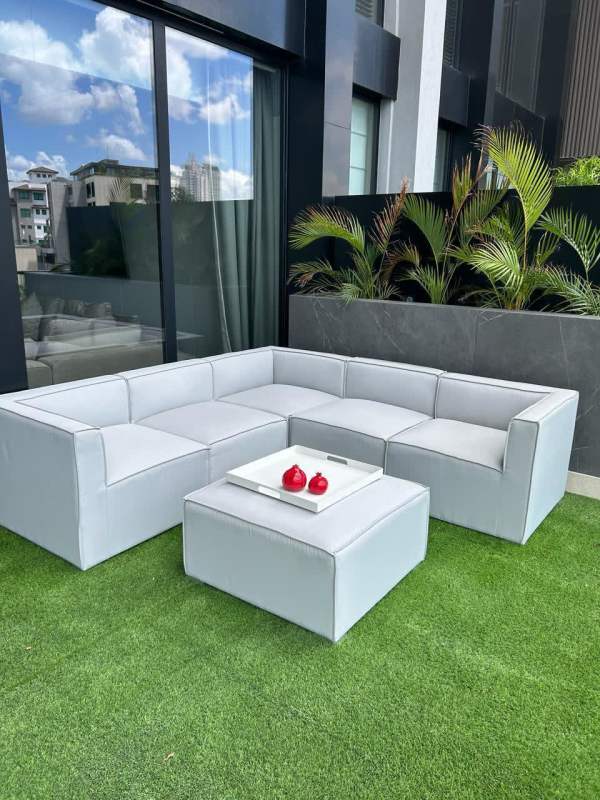 Large living room with wall mounted TV, gray sofas, art in Santa Maria Golf Condo Panama