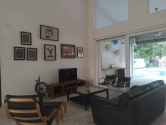 Bright living room high ceilings view to pool Coronado Golf Panama