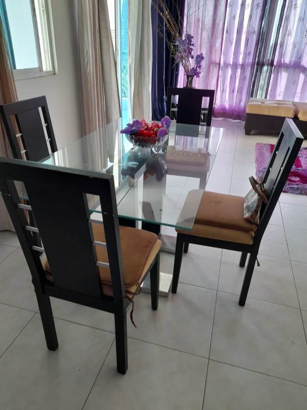 Dining area with glass table large windows PH Plaza Edison Panama