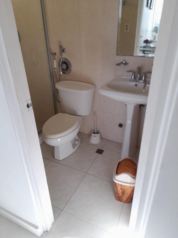 Compact bathroom with pedestal sink glass shower PH Plaza Edison Panama