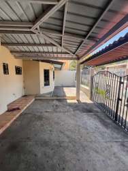 Covered carport with metal roofing on house for sale Brisas de Arraiján Panama