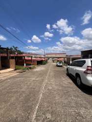 Residential street with driveways and covered parking at Brisas de Arraiján Panama