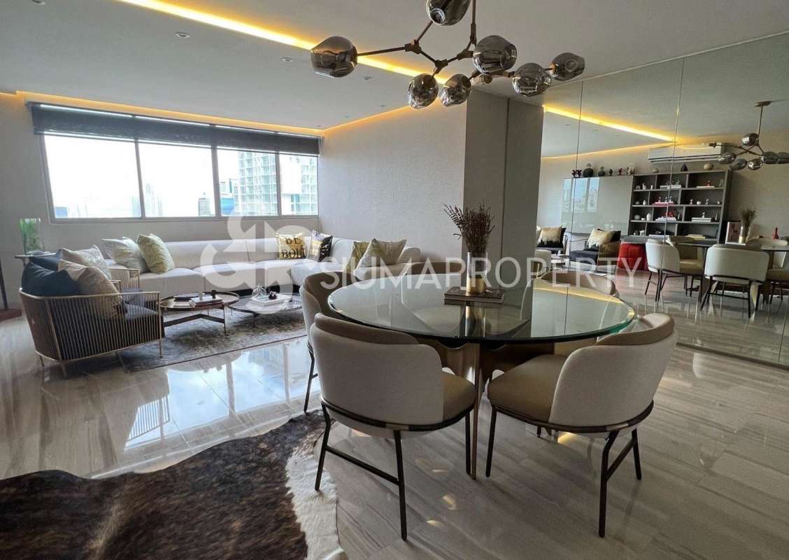 Glass dining table with upholstered chairs, mirrored panels, chandelier in PH Marbella Tower 1 Panama