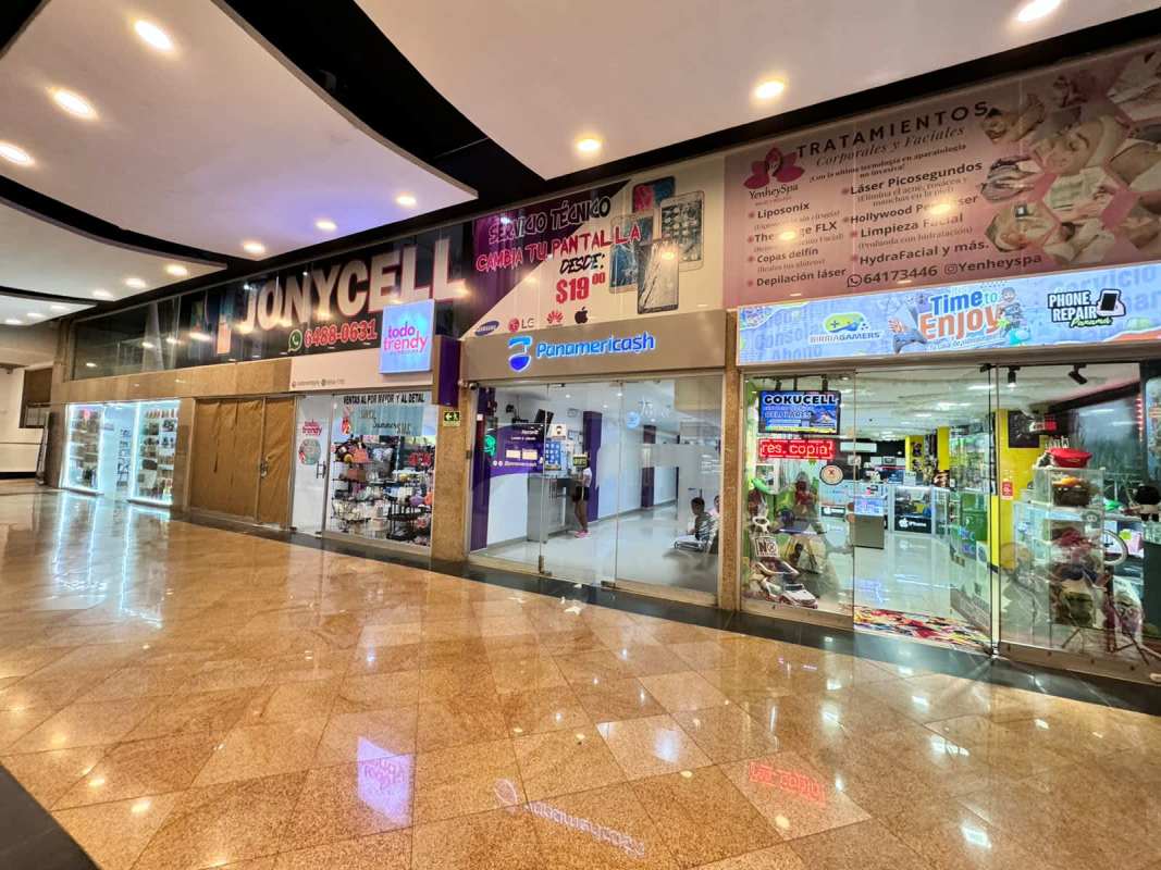 Corridor inside Dorado Mall showing electronics and phone repair shops Panama