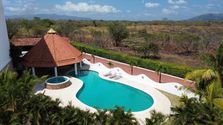 Ocean view covered balcony with seating area in beachfront condo Punta Barco Resort