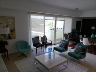 Modern open plan living dining area with large windows and bright decor in Eagles Landing Panama