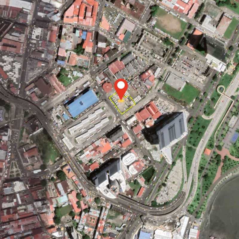 Satellite view of mixed-use city district highlighting commercial property location among buildings, parks, and roads