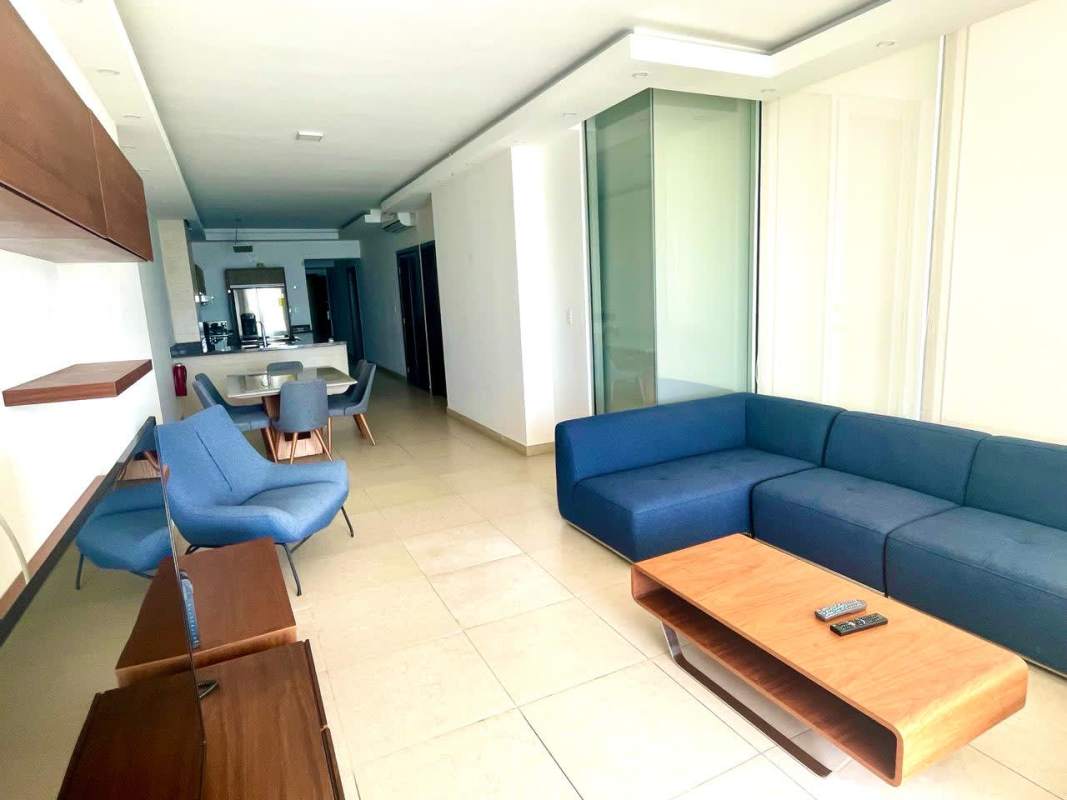 Open dining and living room with large windows and oceanfront balcony at PH Rivage Tower Panama