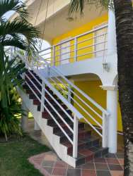 Yellow colonial style guest building with arches and gardens Casa Amarilla Punta Chame