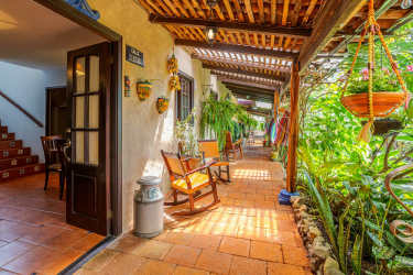 Mediterranean veranda with terracotta tiles and wooden pergola in Alto Boquete hotel Panama