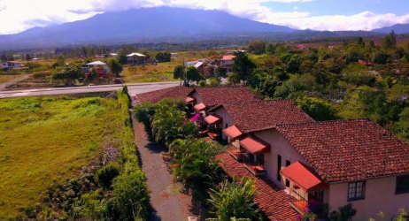 Minimalist bedroom with two beds and large window overlooking gardens in Boquete boutique hotel