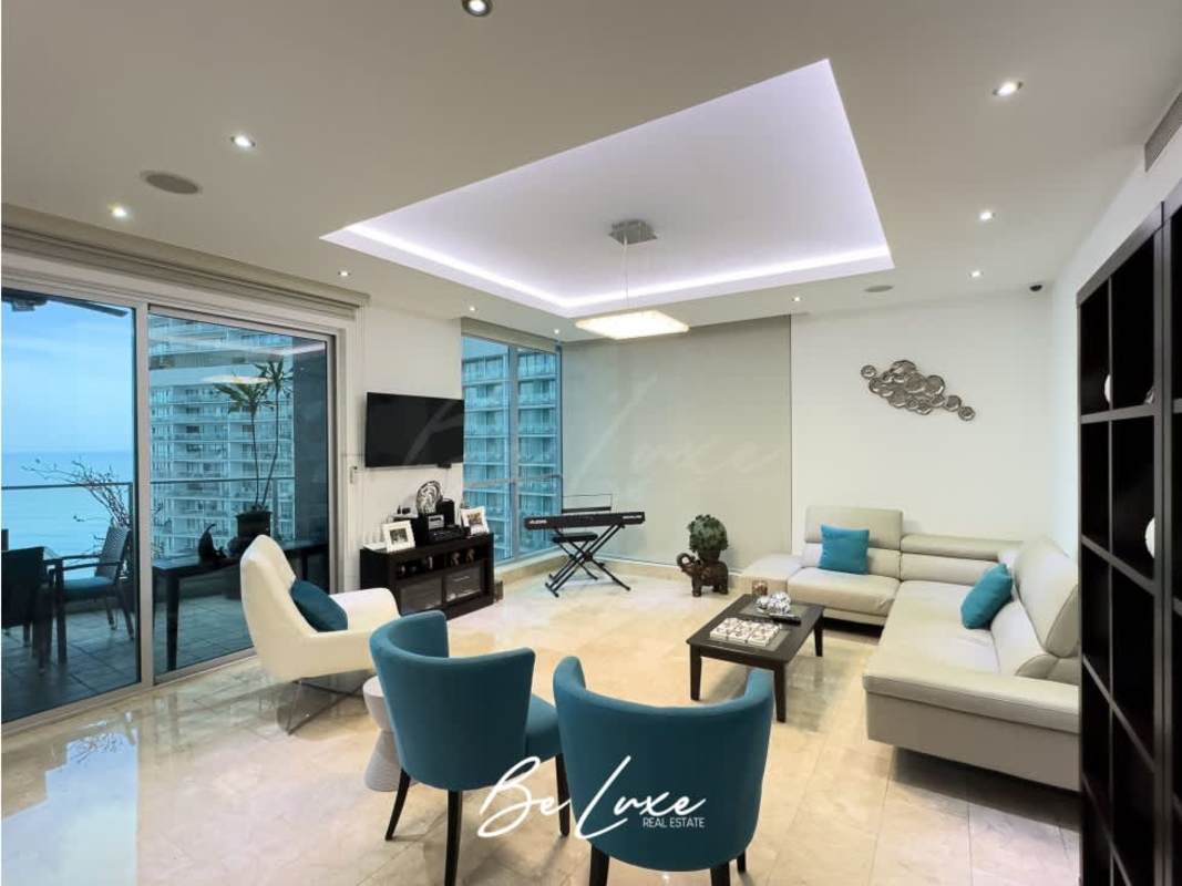 Open living room with marble floors, floor-to-ceiling windows and ocean view in Punta Pacífica Panama