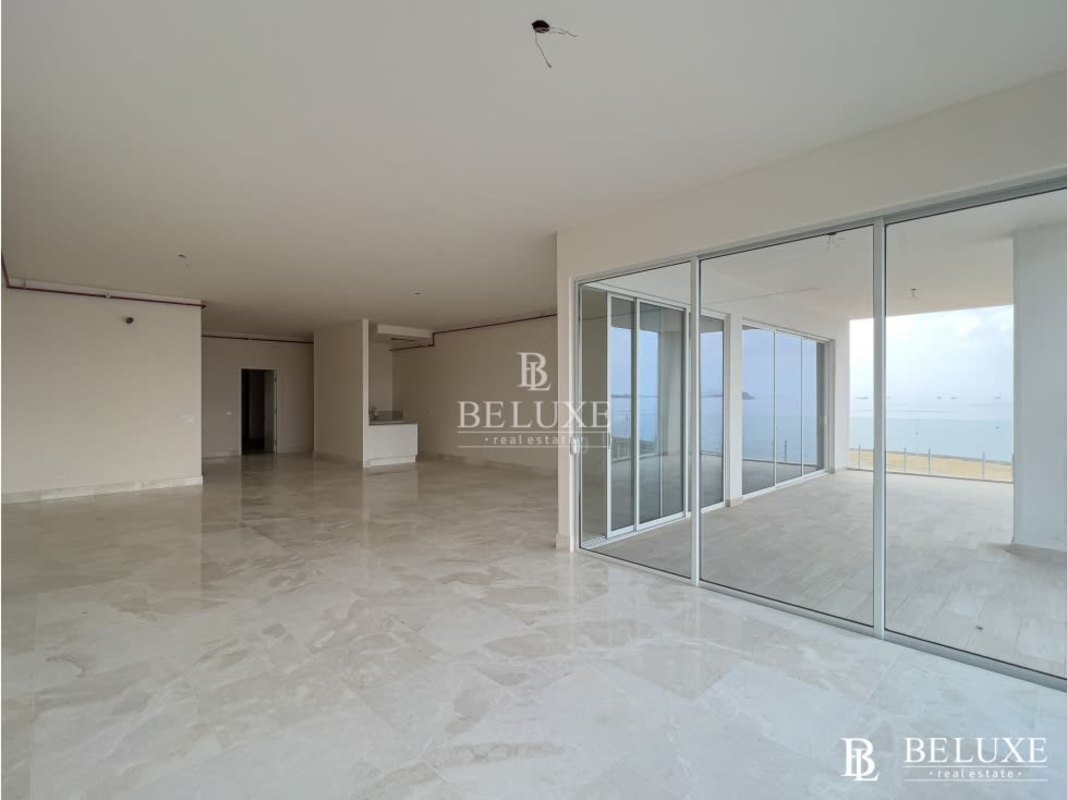 Bright open living area with floor-to-ceiling windows overlooking Ocean Reef Island marina