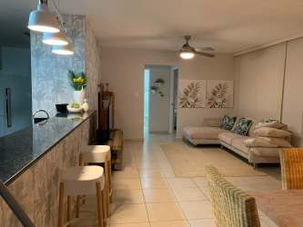 Modern kitchen with granite countertops, wooden cabinets and full appliances in PH Bijao Panama