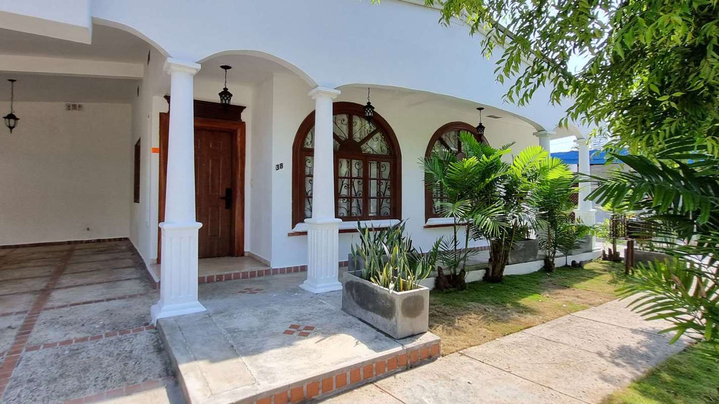 Mediterranean style commercial house in Obarrio Panama with arched windows, porch, garden and driveway for parking