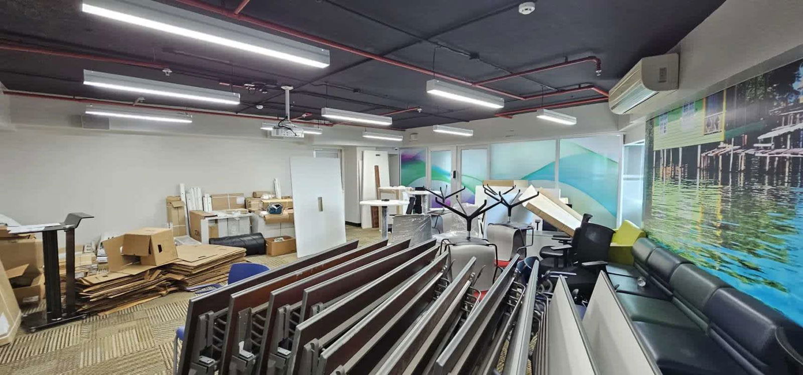 Office under renovation glass walls, mural, lighting, suspended ceiling in Banking District Calle 50 Panama