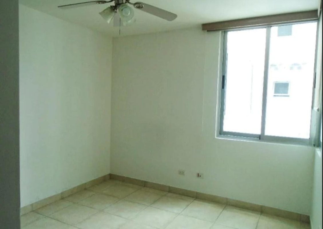 Modern gym with exercise equipment and large windows at PH Clayton Park Panama