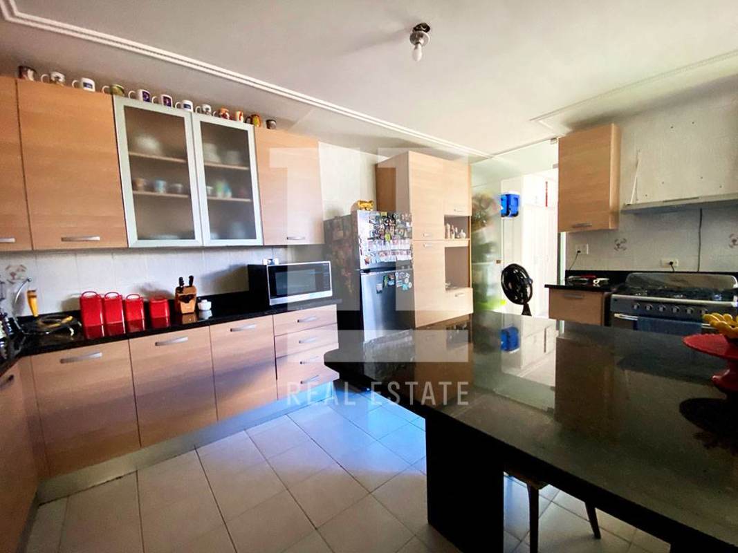 Spacious kitchen with granite countertops and wood cabinetry PH Coco Palace Panama
