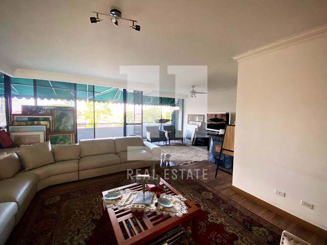 Bright living room with large windows and balcony access PH Coco Palace Panama City