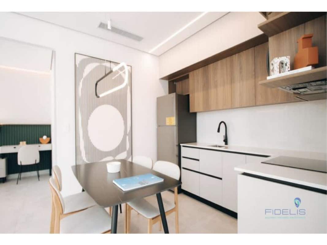 Open kitchen and dining space with wood cabinetry, minimalist style at Generation Tower Costa del Este