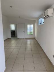 Bright bedroom with ceramic tile floor, large window, and built-in closet in Brisas del Golf Arraiján house Panama