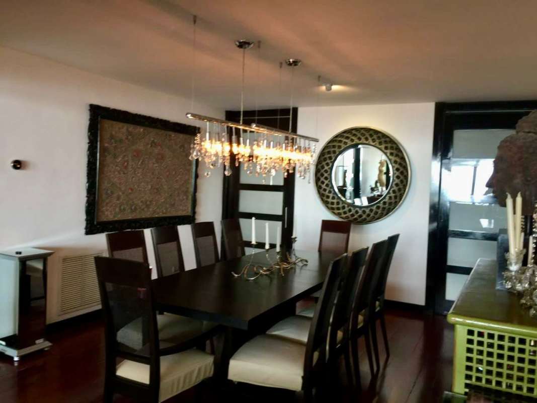 Contemporary luxury apartment living room with large mirror and panoramic ocean skyline view in PH Camino Real Panama