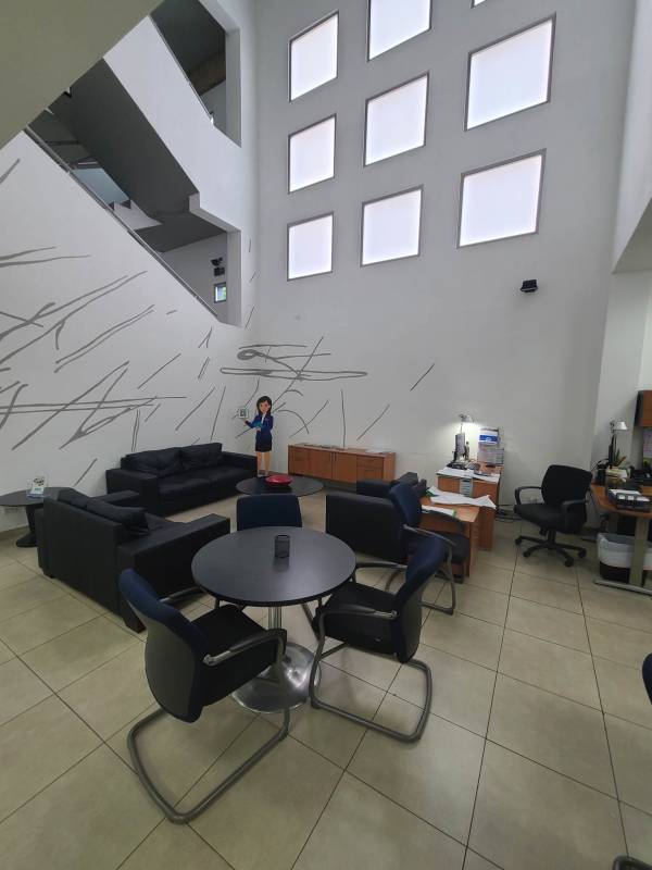 Lobby with tile floors reception furniture tall wall windows abstract art San Francisco Panama