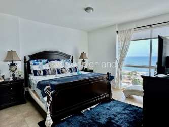 Guest bedroom with large window and closet in Playa Blanca Panama