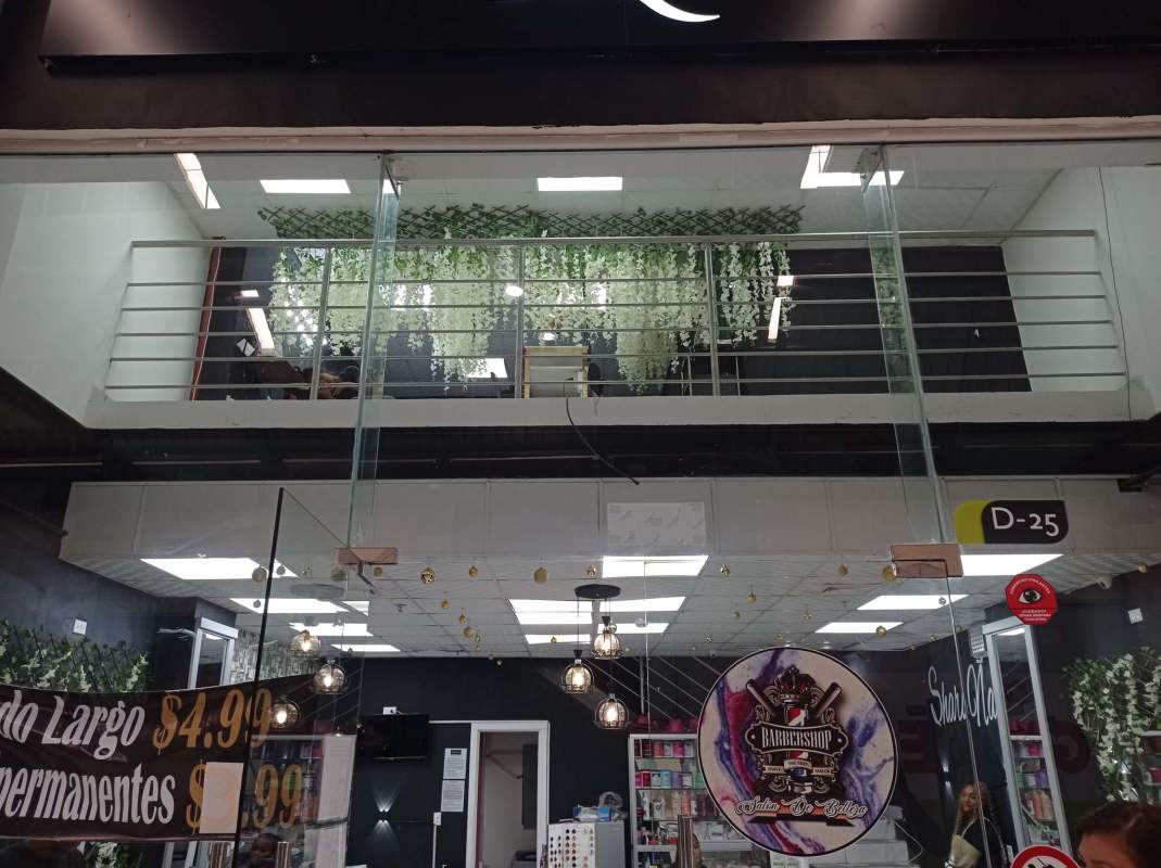 Salon interior with product displays, mirrors, pendant lights inside commercial space in Mega Mall