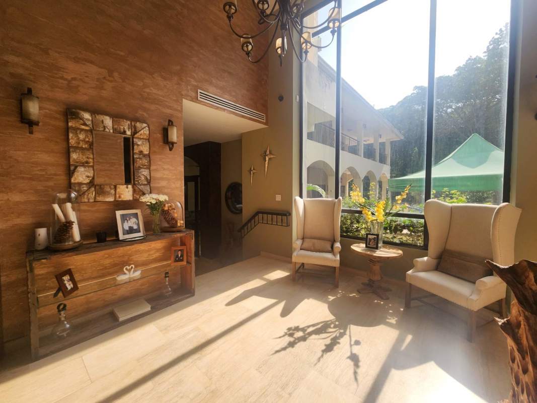 Spacious kitchen with island, wooden cabinets and built-in appliances in Clayton Panama luxury villa