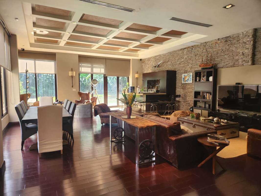 Spacious living-dining area with marble floors, chandelier, large windows in luxury house Clayton Panama