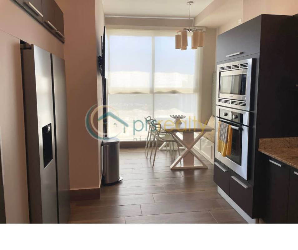 Bright modern kitchen and dining nook with large window in PH Titanium Costa del Este Panama