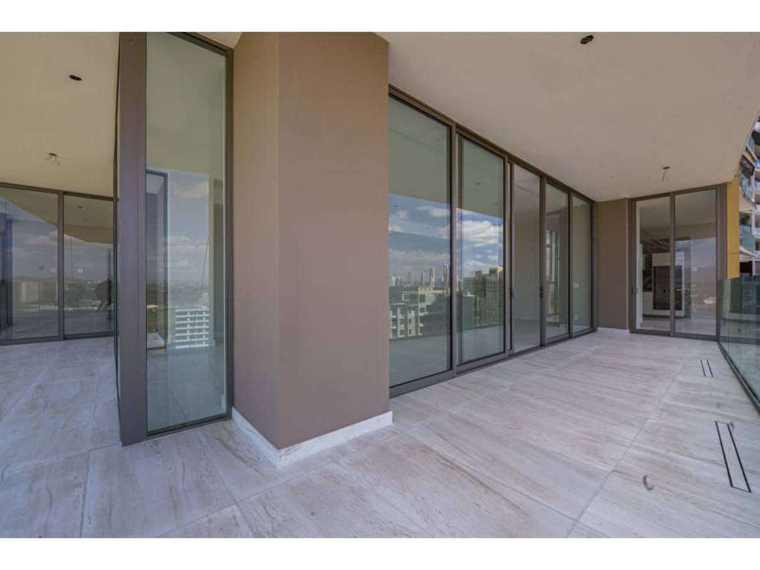 Luxury bathroom featuring freestanding tub, glass shower, gold fixtures, floor-to-ceiling window at La Maison by Fendi Santa Maria Panama