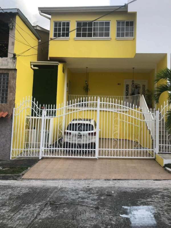 Living room with stone accent wall, mounted TV, sectional sofa in Residencial Limajo Panama