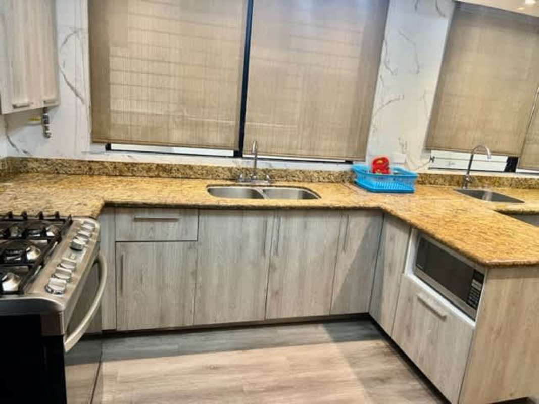 Remodeled bathroom with glass shower, vanity, and tiles in Punta Paitilla Panama apartment