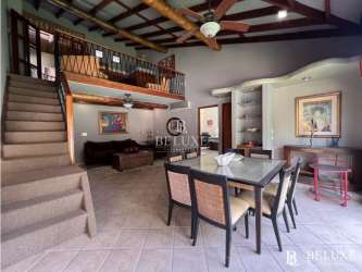 Open living and dining room with loft ceiling Coronado house Panama