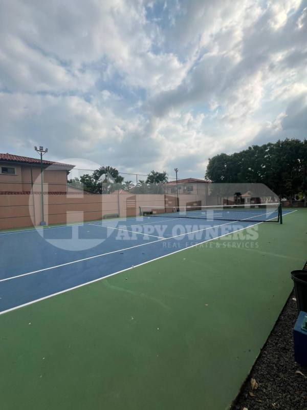 Outdoor tennis facility with wall enclosure and lighting at Residencial Versalles Don Bosco Panama