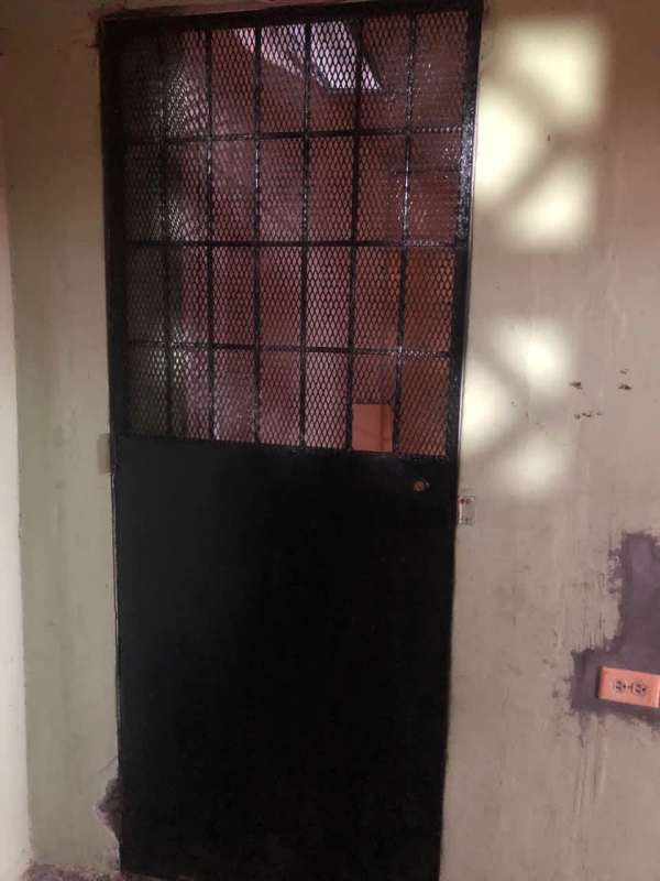 Utility storage space with metal mesh door in affordable house Panama City